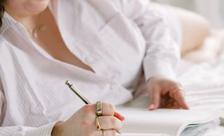 Woman Writing on her bed for Pen Pal Coaching Services