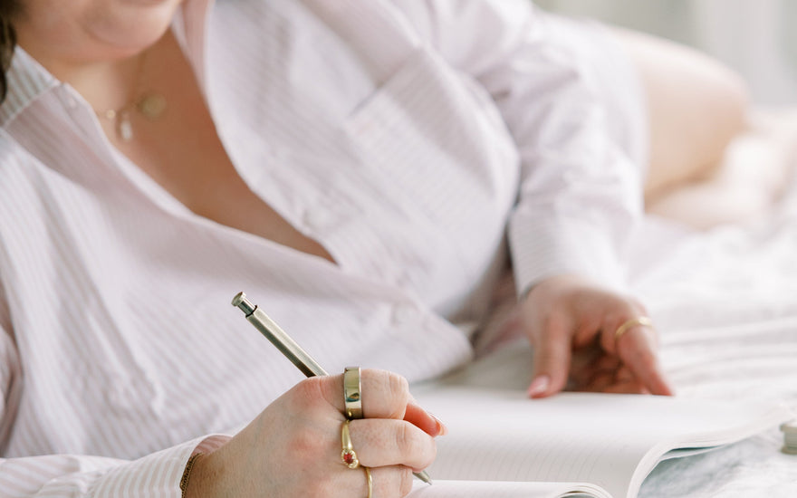 Woman Writing on her bed for Pen Pal Coaching Services